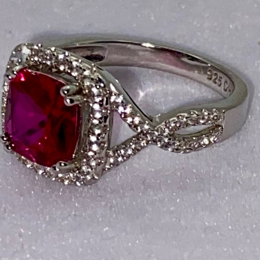 Lab created Ruby with lab created white sapphire’s accent in SS ring